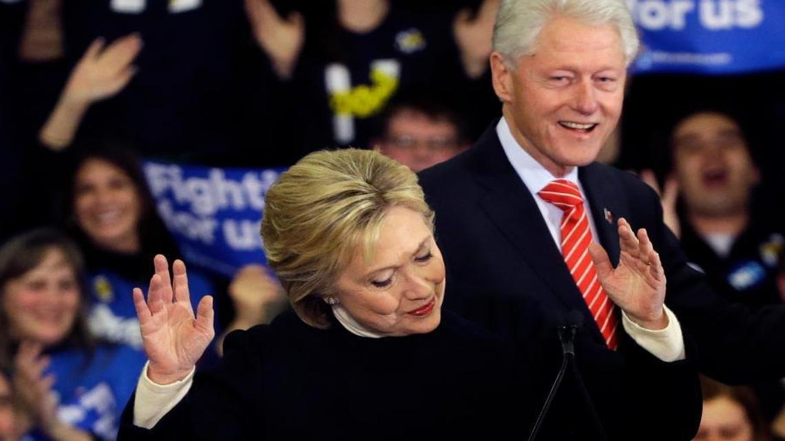 Democratic presidential candidate Hillary Clinton reacts as former President Bill Clinton smiles at her New Hampshire presidential primary campaign rally, Tuesday, Feb. 9, 2016, in Hooksett, New Hampshire.