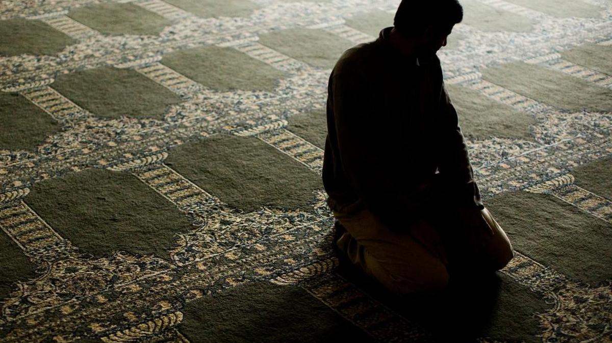 A Syrian refugee, who agreed to be photographed on condition of anonymity because of fear of retaliation against family living in Syria, prays on Wednesday, Nov. 18, 2015, at the Muslim Association of Lehigh Valley in Whitehall, Pa.