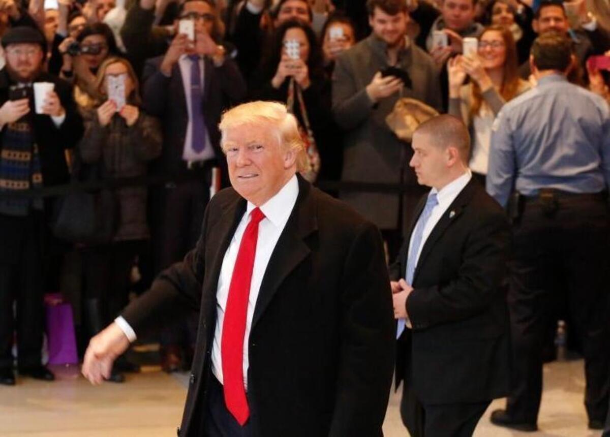President-elect Donald Trump walks past a crowd as he leaves the New York Times building following a meeting Tuesday, Nov. 22, 2016, in New York.