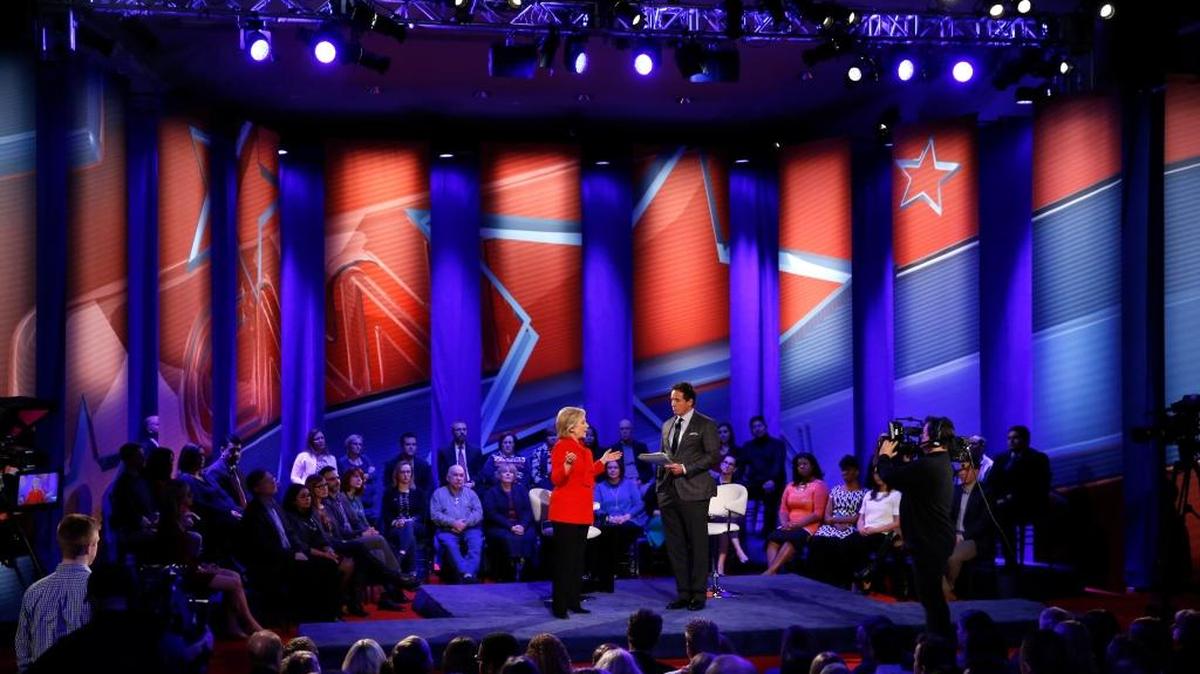 Democratic presidential candidate Hillary Clinton, left, speaks with host Chris Cuomo during a CNN town hall at Drake University in Des Moines, Iowa, Monday, Jan. 25, 2016.