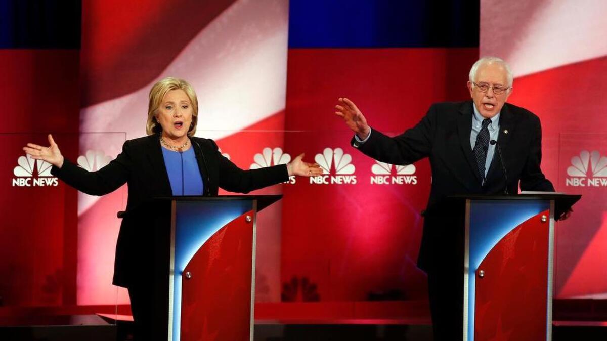 Democratic presidential candidates, former Secretary of State Hillary Clinton, left, and Sen. Bernie Sanders, I-Vt. talk over each other during the Democratic presidential primary debate at the Gaillard Center, Sunday, Jan. 17, 2016, in Charleston, S.C.