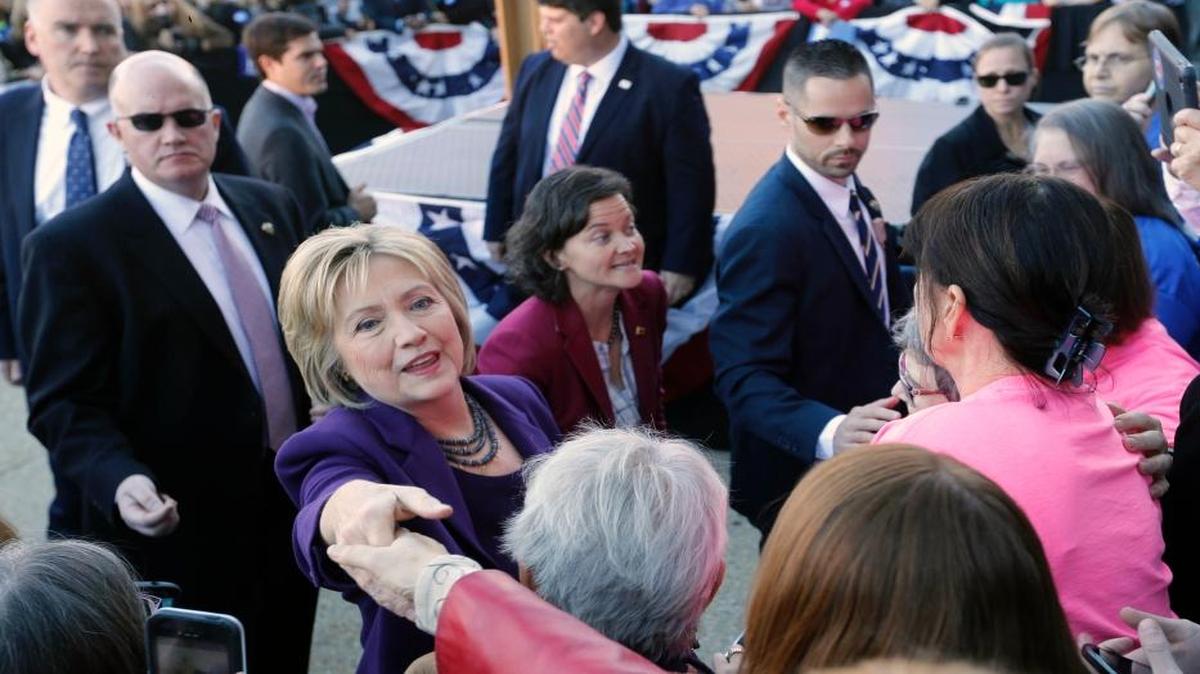 Hillary Clinton reaches out to shake hands after filing papers to be on the nation’s earliest presidential primary ballot, Monday, Nov. 9, 2015, at The Secretary of State’s Office in Concord, N.H.