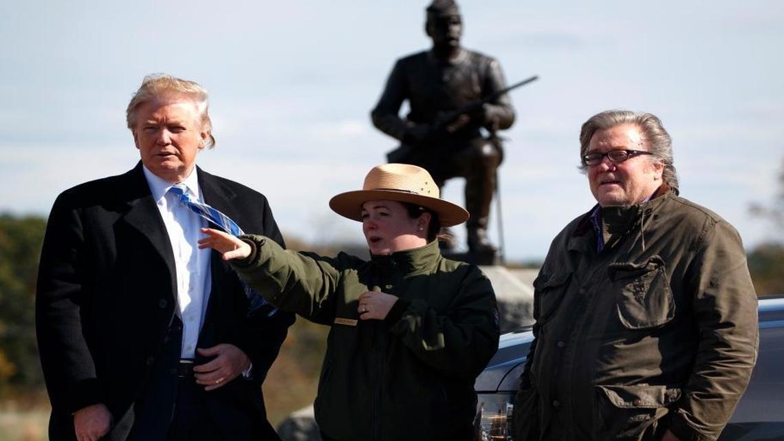 Interpretive park ranger Caitlin Kostic, center, gives a tour near the high-water mark of the Confederacy at Gettysburg National Military Park to Republican presidential candidate Donald Trump, left, and campaign CEO Steve Bannon, Saturday, Oct. 22, 2016, in Gettysburg, Pa.