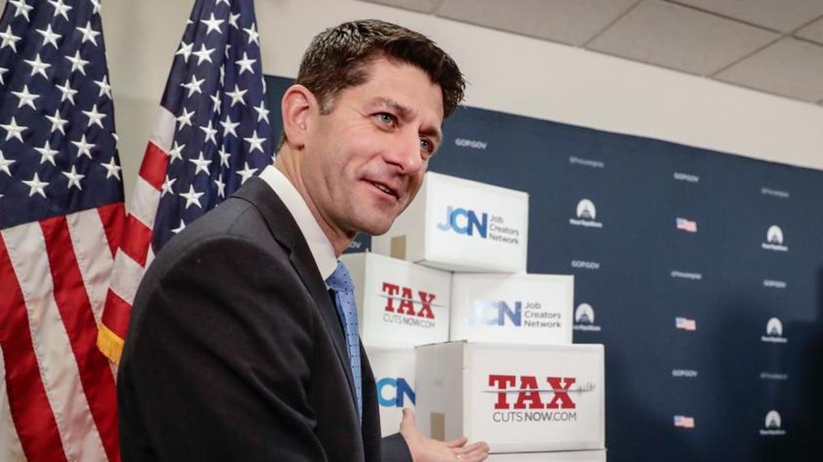 Speaker of the House Paul Ryan, R-Wis., points to boxes of petitions supporting the Republican tax reform bill.