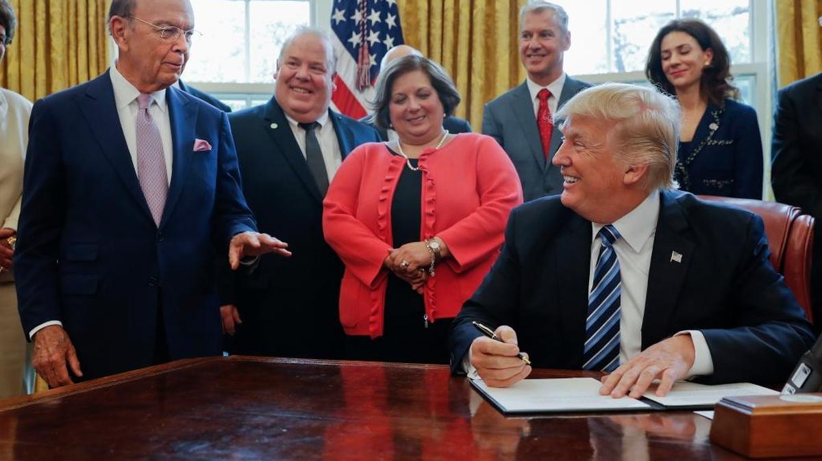 President Donald Trump looks toward Commerce Secretary Wilbur Ross, left, before signing a Memorandum on Aluminum Imports and Threats to National Security, Thursday, April 27, 2017, in the Oval Office of the White House in Washington. Trump will direct his administration to expedite a new investigation in whether aluminum imports are jeopardizing U.S. national security.