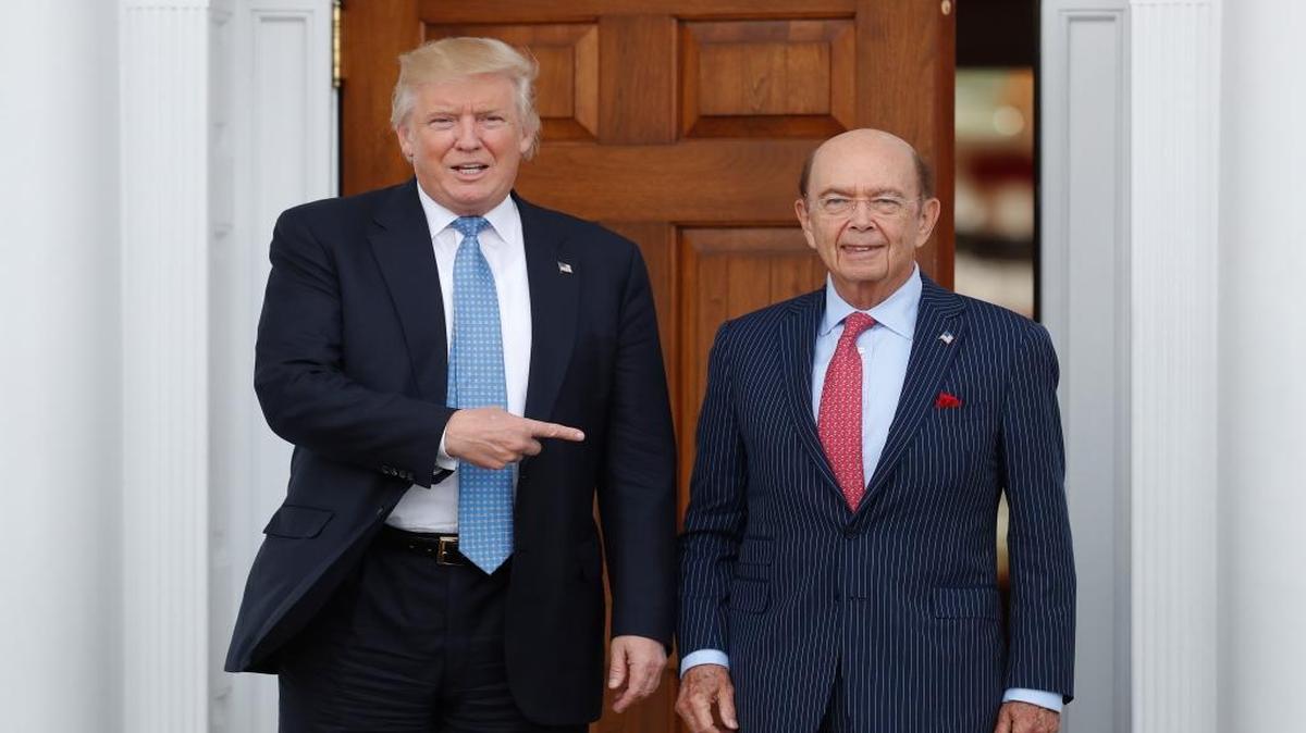 FILE - In this Sunday, Nov. 20, 2016, file photo, President-elect Donald Trump, left, stands with investor Wilbur Ross after meeting at the Trump National Golf Club Bedminster clubhouse in Bedminster, N.J. Trump is poised to offer the position of commerce secretary to the head of a private-equity firm, Wilbur Ross.