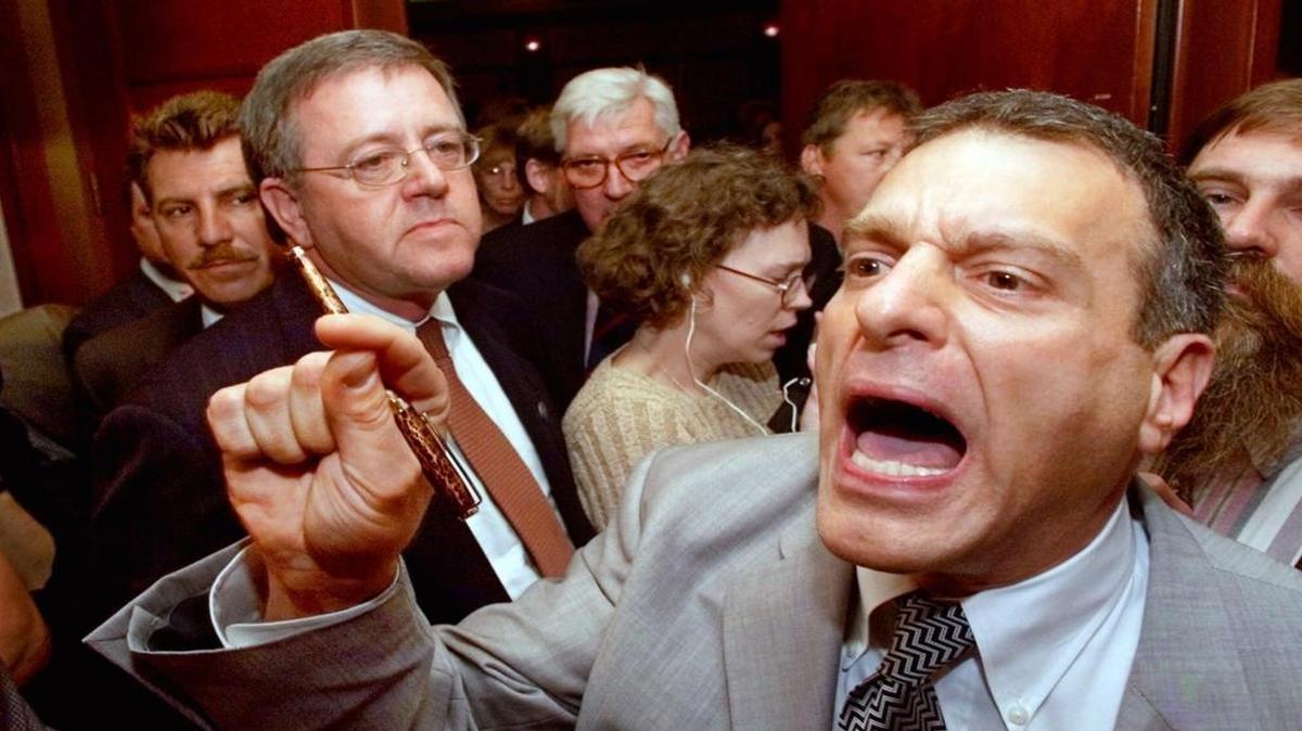 In this 2000 file photo, Jim Mangia, the national secretary for the Reform Party, points as he leads a group of national committee members walking out of the party’s credential committee meeting in Long Beach.