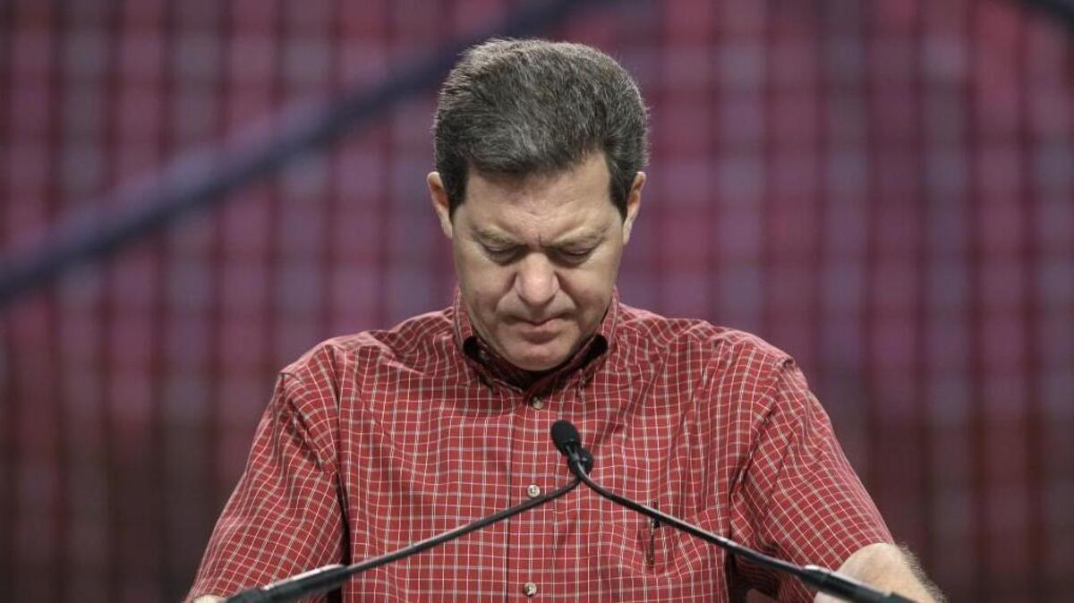Kansas Gov. Sam Brownback prays in 2011. His final proclamation as governor invites Kansans to pray and fast on his last full day in office Wednesday, Jan. 31, 2018.