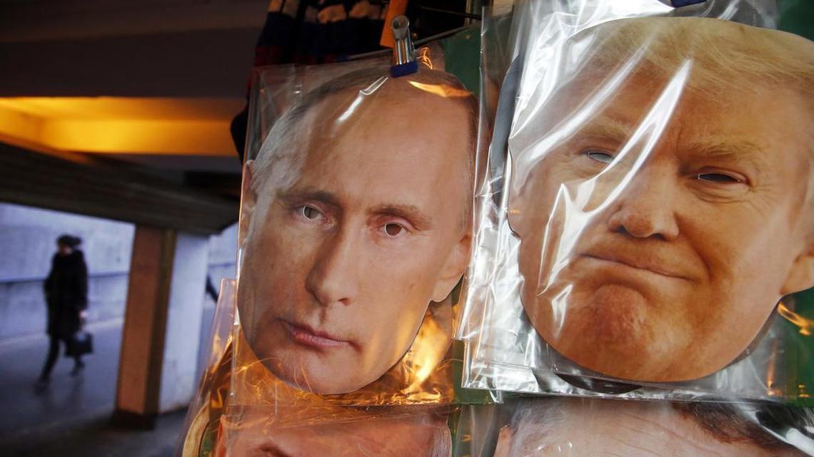 Face masks depicting Russian President Vladimir Putin and U.S. President-elect Donald Trump hang for sale at a souvenir street shop in St.Petersburg, Russia, Friday, Dec. 23, 2016.