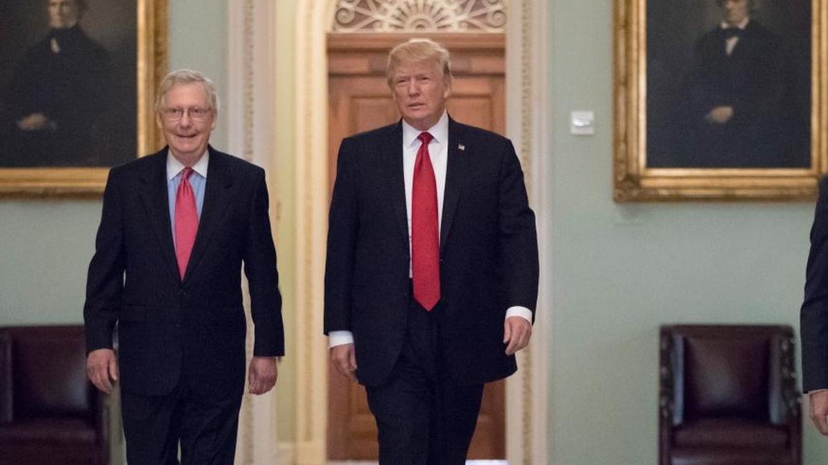 President Donald Trump, escorted by Senate Majority Leader Mitch McConnell, R-Ky., left, arrives on Capitol Hill to have lunch with Senate Republicans and push for his tax reform agenda, in Washington Tuesday.