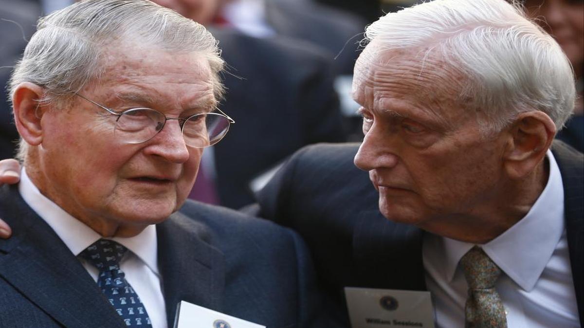 Former FBI Directors William Webster, left, and William Sessions speak before President Barack Obama and FBI Director James Comey arrive at an installation ceremony at FBI Headquarters in Washington, Oct. 28, 2013.