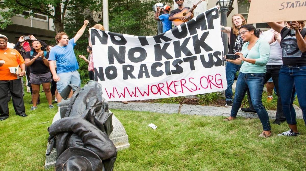 A group of protesters cheer after toppling Confederate soldier statue during an “Emergency Durham Protest” at the old Durham County Courthouse in response to the violent protests Saturday in Charlottesville, on Monday, Aug. 14, 2017, in Durham, NC. The group proceeded to march to the site of the new police headquarters under construction.