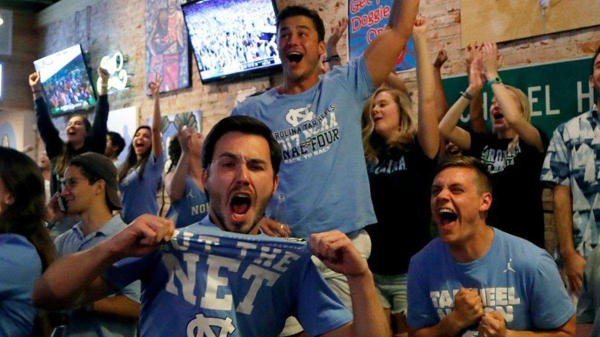 UNC fans go wild after a big play for the Tar Heels as they watch the NCAA game against Oregon at Sup Dogs restaurant on Franklin Street in Chapel Hill on April 1, 2017.