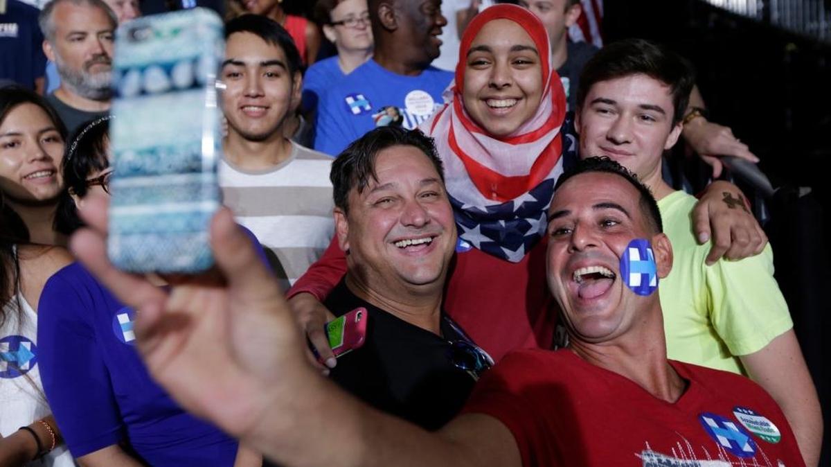 Javier Conde of Miami takes a selfie with Hillary Clinton supporters during the first campaign rally with Clinton’s running mate, Virginia Sen. Tim Kaine, at Florida International University.