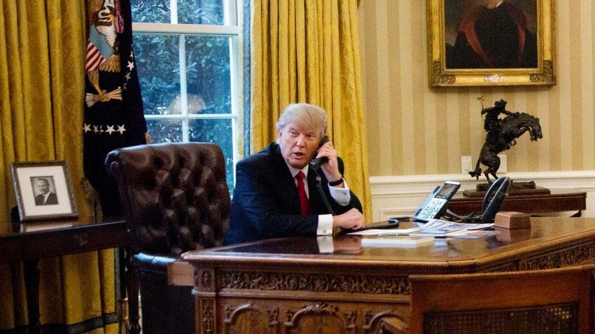 President Donald Trump speaks on the phone with King of Saudi Arabia Salman bin Abd al-Aziz Al Saud in the Oval Office at the White House in Washington, Sunday, Jan. 29, 2017.