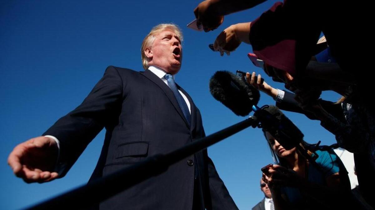 President Donald Trump speaks with reporters before boarding Air Force One at Morristown Municipal airport, in Morristown, N.J. (AP Photo/Evan Vucci, File)