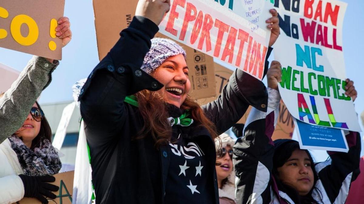 A DACA recipient and student, Linda David, center and her sister Natalie David, right, voice their opposition to the immigration and refugee policies of President Donald Trump during a rally on Halifax Mall on Saturday Feb. 4, 2017, in Raleigh, NC.