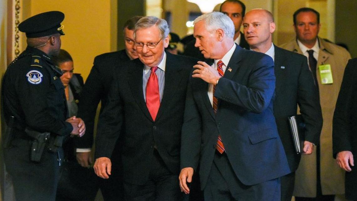 Vice President-elect Mike Pence talks with Senate Majority Leader Mitch McConnell of Kentucky as they walk on Capitol Hill in Washington Tuesday.