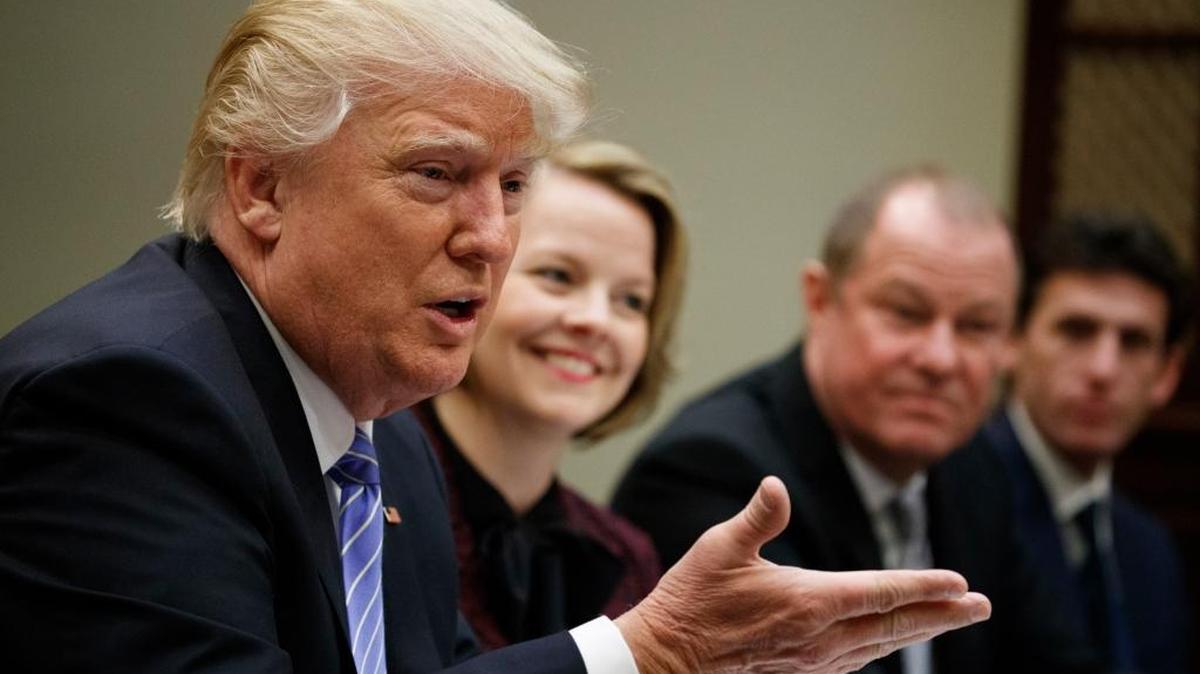 President Donald Trump speaks during a meeting with retail industry leaders in the Roosevelt Room of the White House in Washington on Wednesday. From left are, Trump, Jo-Ann Craft Stores CEO Jill Soltau, Gap Inc. CEO Art Peck and Jeremy Katz, an adviser to National Economic Council director Gary Cohn.