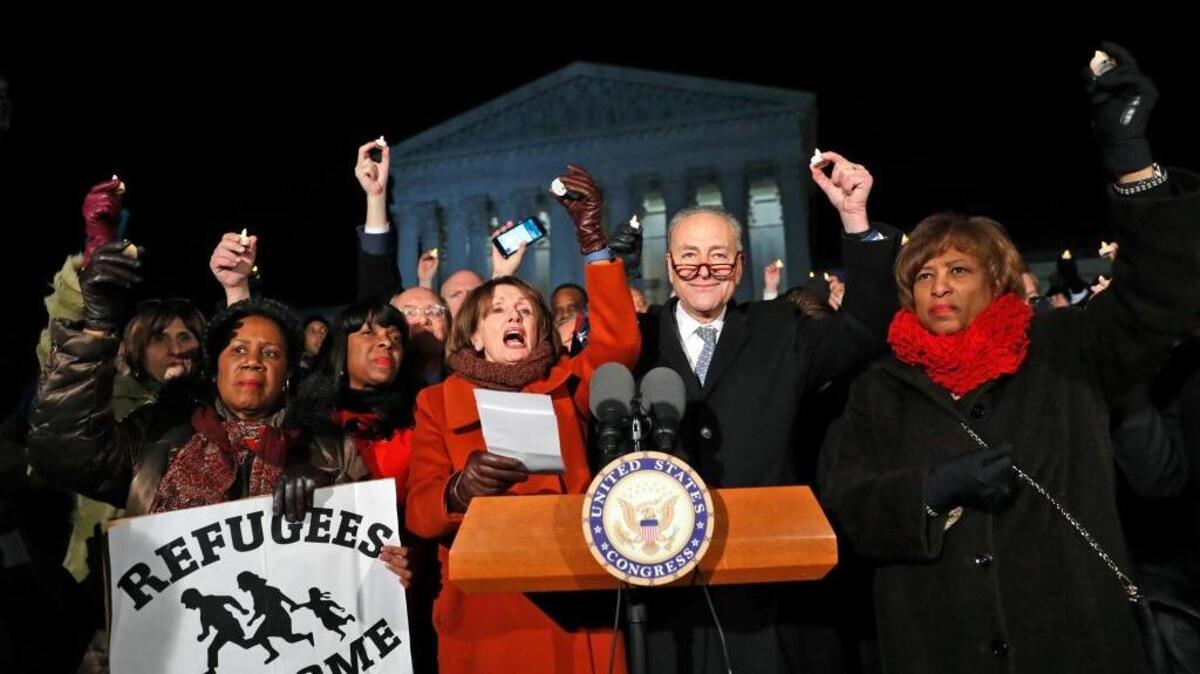 Rep. Sheila Jackson Lee D-Texas, left, House Minority Leader Nancy Pelosi of Calif., Senate Minority Leader Chuck Schumer of New York, Rep. Brenda Lawrence, D-Mich., right, and other members of Congress, held small candles aloft in front of the Supreme Court during a news conference about President Donald Trump's recent executive orders, Monday, Jan. 30, 2017 in Washington.