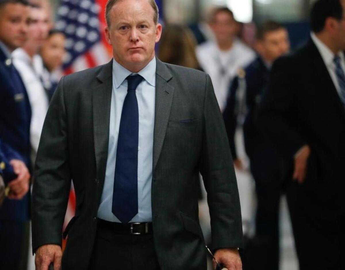 White House press secretary Sean Spicer walks down the hallway during President Donald Trump's visit to the Pentagon, Thursday. Spicer has resigned over hiring of new communications aide.