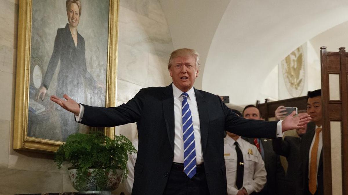 President Donald Trump greets visitors touring the White House in Washington, Tuesday, March 7, 2017. The president greeted the first wave of tourists to come through the White House since he assumed office, welcoming a small crowd of visitors in the East Wing, waving from behind a velvet rope as the crowd screamed, cheered and took photos.