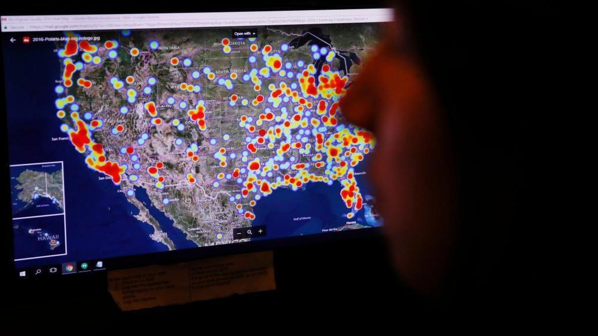 A hotline advocate works at the Human Trafficking Hotline call center last year in Washington. The U.S. map behind her shows cases of trafficking reported through the hotline in 2016.