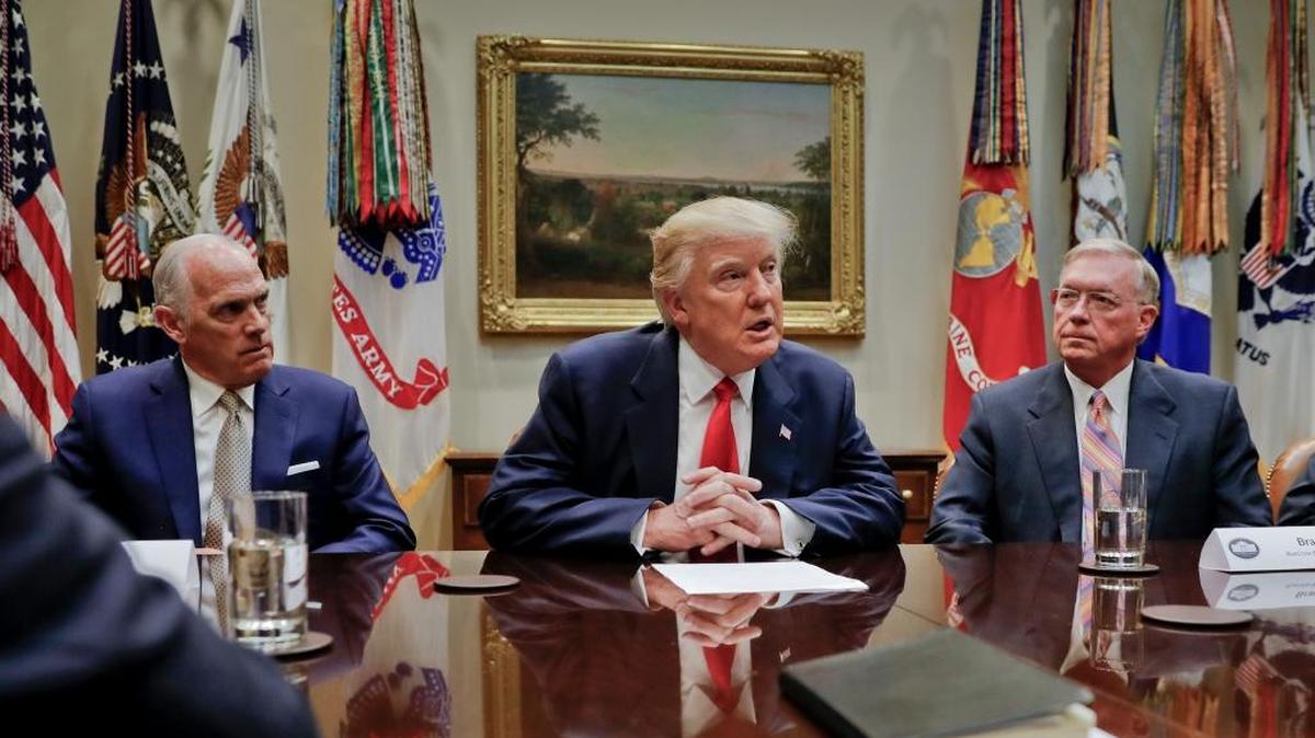 President Donald Trump, flanked by Independence Blue Cross CEO Daniel J. Hilferty, left, and Blue Cross and Blue Shield of North Carolina CEO Brad Wilson, speaks during a meeting with health insurance company executives in the Roosevelt Room of the White House in Washington, Monday, Feb. 27, 2017.