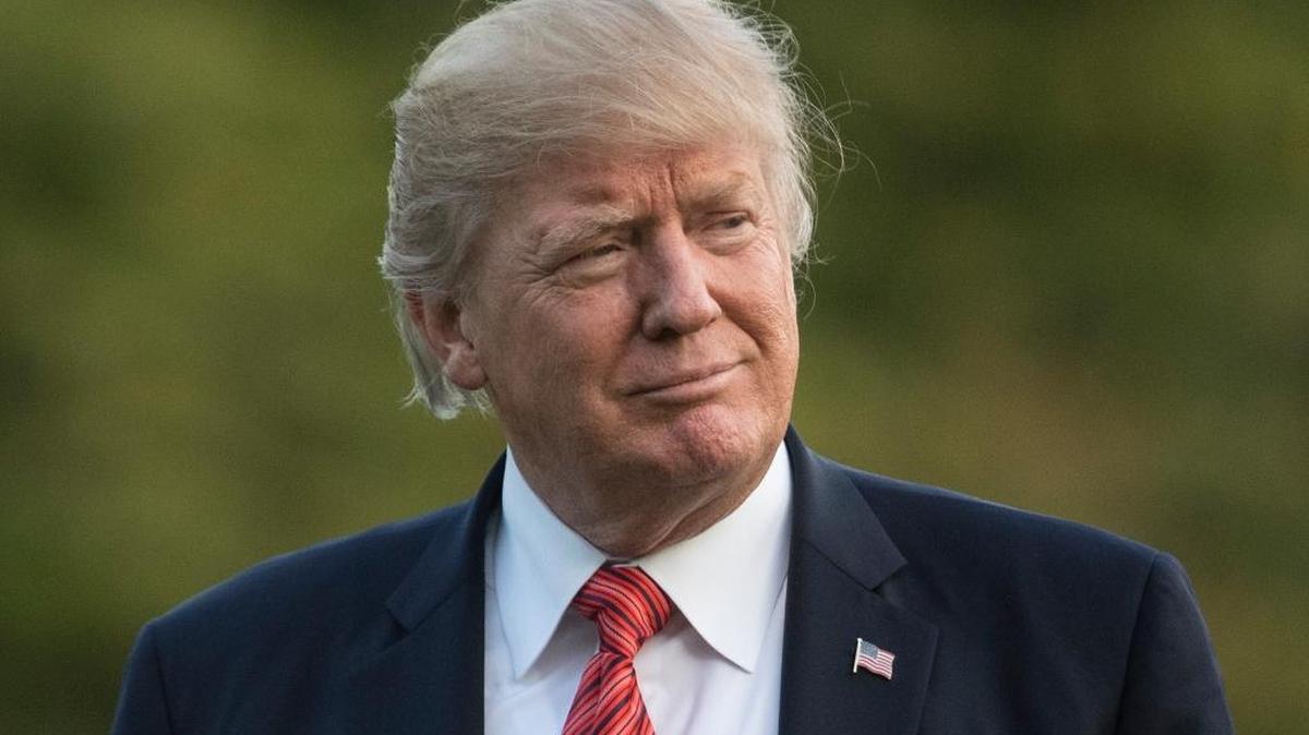 President Donald Trump walks from Marine One across the South Lawn of the White House in Washington, Wednesday, Aug. 23, 2017, as he returns from Reno, Nev.