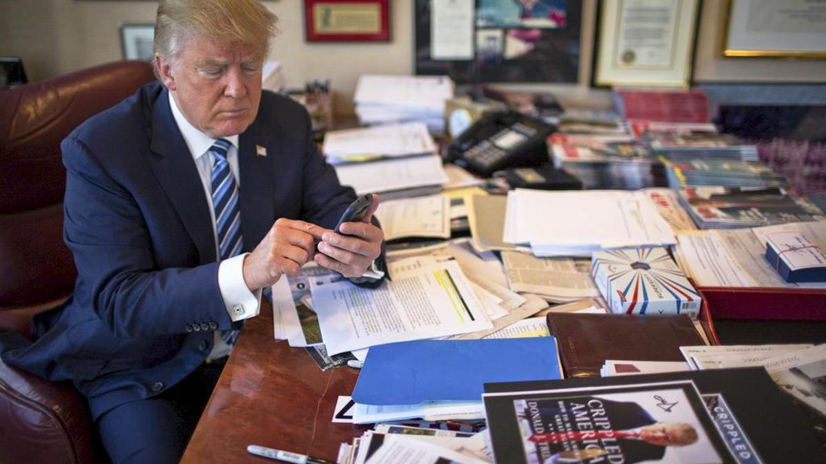 FILE-- Donald Trump demonstrates his tweeting skills in his office at Trump Tower in New York, Sept. 29, 2015. China’s leaders thought they had a solution to the torrent of snark, jibes and condemnation on Twitter: They banned access to it at home. Yet in a twist, China has become the country that the now President-elect seems to enjoy criticizing the most on his open-all-hours Twitter feed. (Josh Haner/The New York Times)
