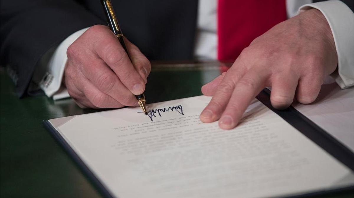 President Donald Trump formally signs his cabinet nominations into law, Friday, Jan. 20, 2017, in the President's Room of the Senate on Capitol Hill in Washington.