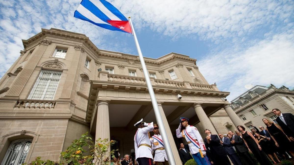 Cuban Foreign Minister Bruno Rodriguez, right of center, applauds with other dignitaries after raising the Cuban flag over their new embassy in Washington, Monday, July 20, 2015.