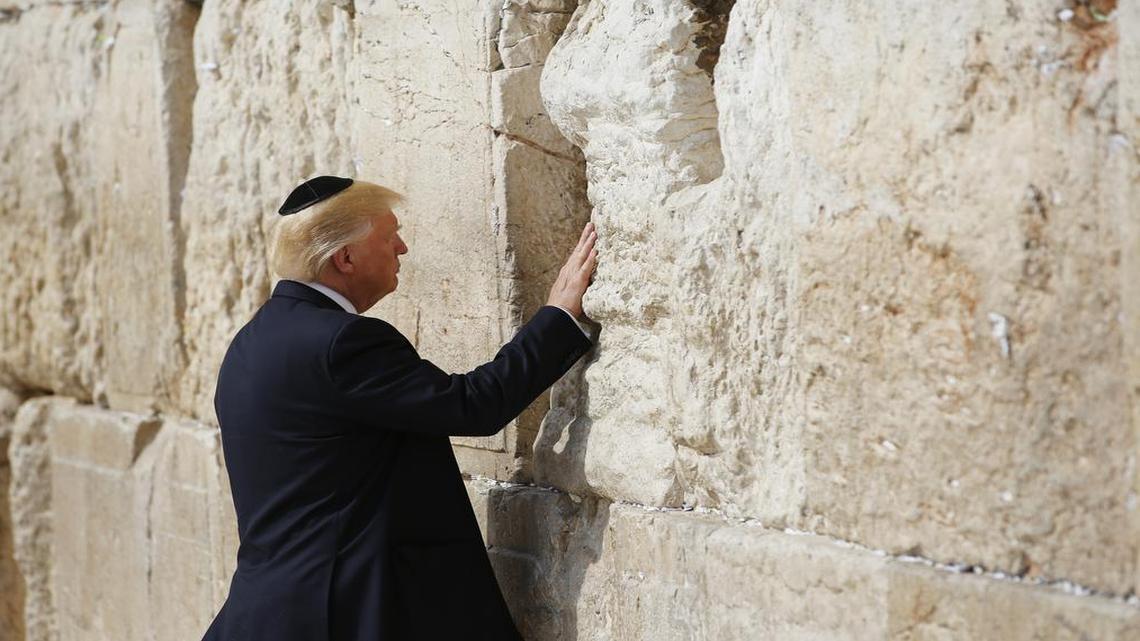 President Donald Trump touches the Western Wall, Judaism’s holiest prayer site, in Jerusalem’s Old City, Monday, May 22, 2017.