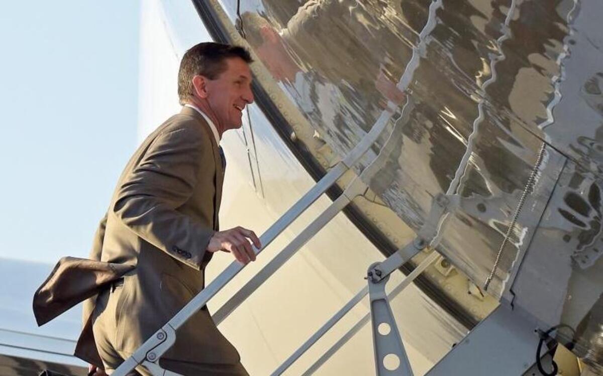 In this Feb. 12, 2017, photo, then-National Security Adviser Michael Flynn boarded Air Force One at Palm Beach International Airport in West Palm Beach, Fla., as he returned to Washington with President Donald Trump. Flynn resigned the next day.