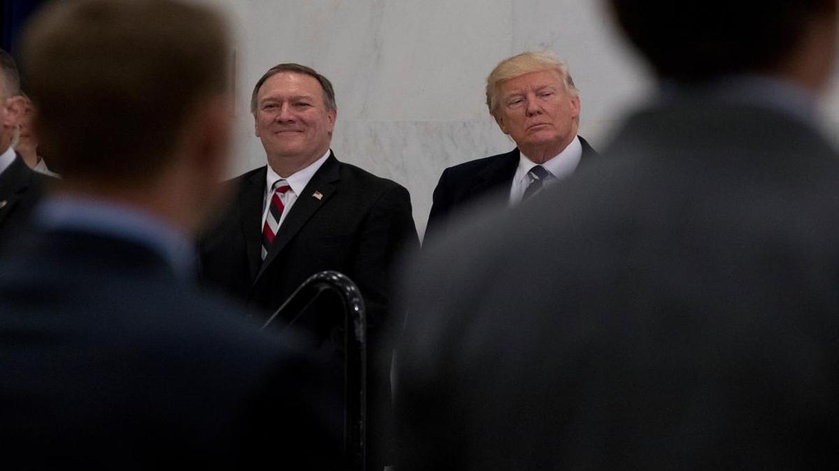 President Donald Trump, accompanied by CIA Director-designate Mike Pompeo, left, waits to speak at the Central Intelligence Agency in Langley, Va., Saturday, Jan. 21, 2017.
