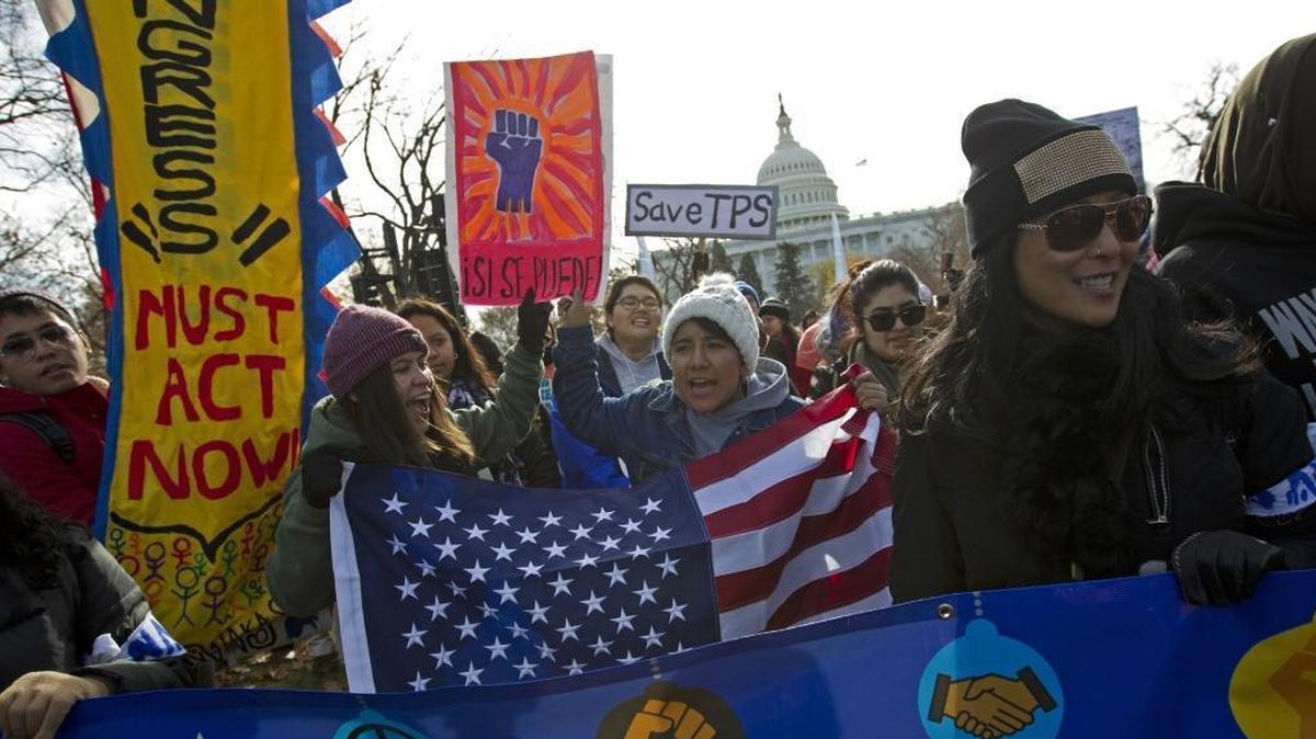 Demonstrators march during an immigration rally in support of the Temporary Protected Status (TPS) and Deferred Action for Childhood Arrivals (DACA), programs on Capitol Hill in Washington, Wednesday, Dec. 6, 2017.