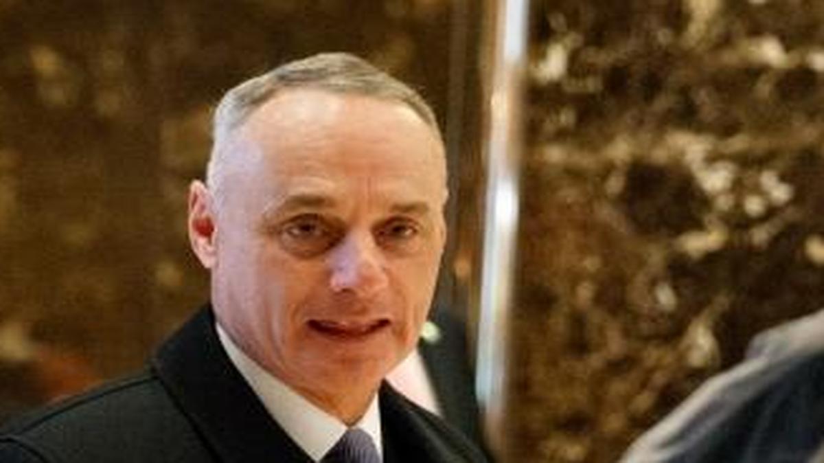 Major League Baseball Commissioner Rob Manfred, left, and New York Yankees President Randy Levine arrive at Trump Tower in New York, Tuesday, Jan. 10, 2017, for a meeting with President-elect Donald Trump.