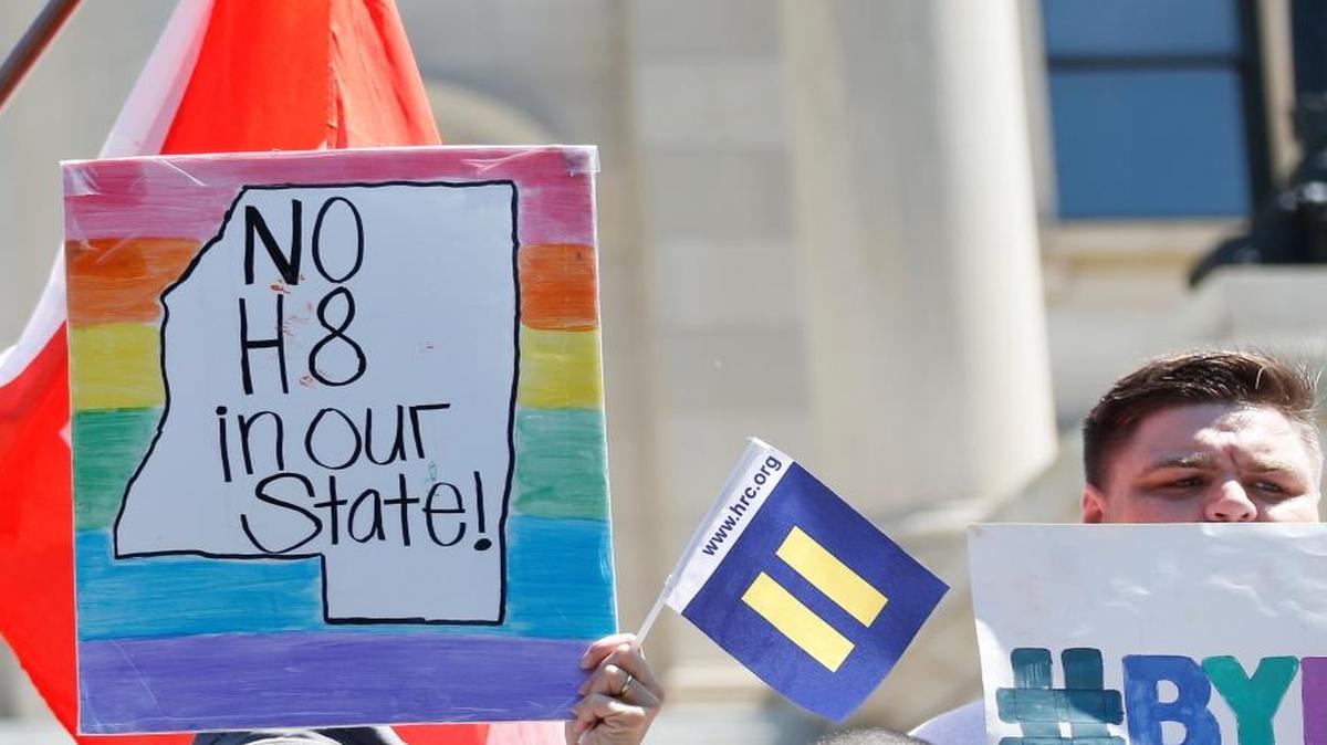LGBT activists waved flags and signs in July after a federal judge blocked a Mississippi law that allowed those who cited religious beliefs to refuse services to gay couples. Opponents of gay marriage are counting on help from President-elect Donald Trump to get Congress to pass a federal bill that addresses the same subject.