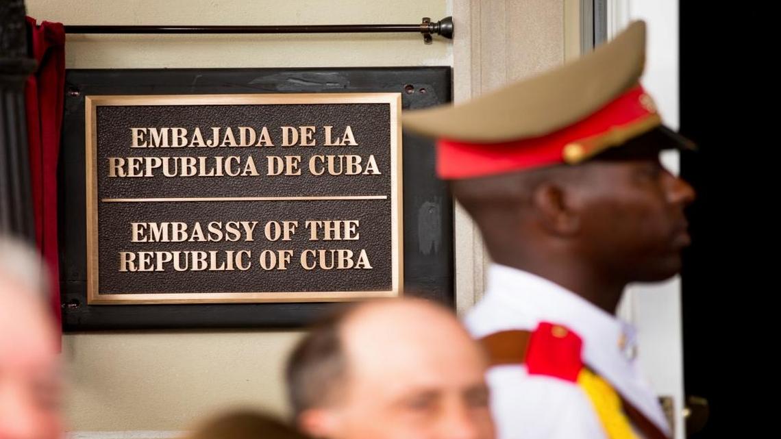 A member of the Cuban honor guard stands next to a new plaque at the front door of the newly reopened Cuban embassy in Washington in this July 20, 2015. The State Department has expelled two diplomats from Cuba’s Embassy in Washington following a series of unexplained incidents in Cuba that left U.S. officials there with physical symptoms.
