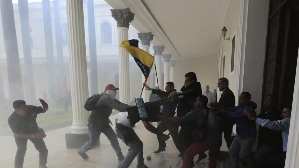 Opposition lawmakers brawl with pro-government militias who are trying to force their way into the National Assembly during a special session coinciding with Venezuela's independence day, in Caracas, on July 5, 2017. At least five lawmakers were injured in the attack. (AP Photos/Fernando Llano)