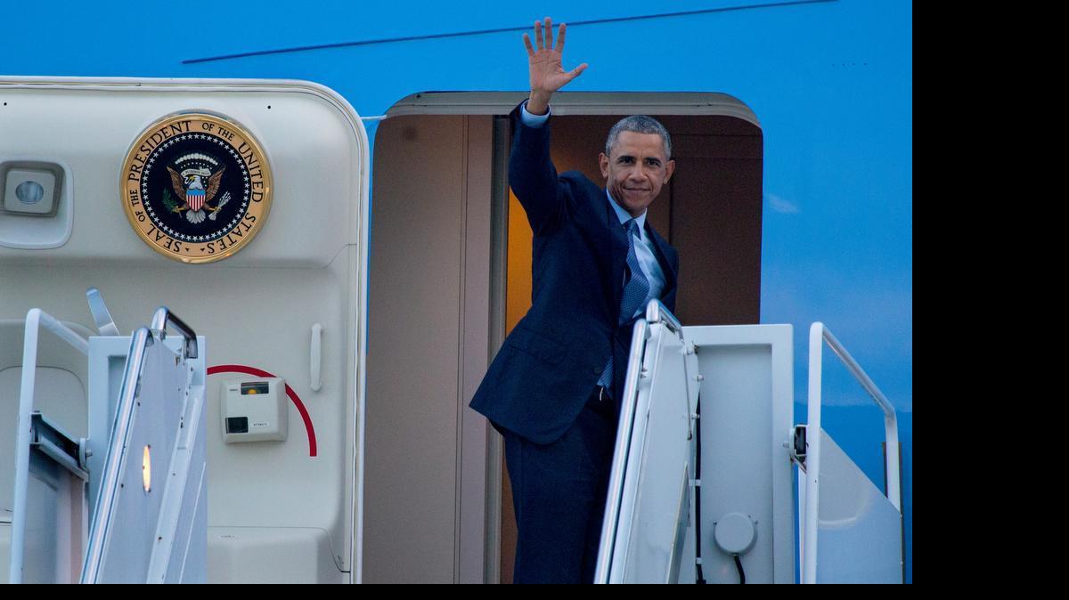 
President Barack Obama waves as he boards Air Force One just before departing John F. Kennedy International Airport in New York, Tuesday, July 21, 2015. 
