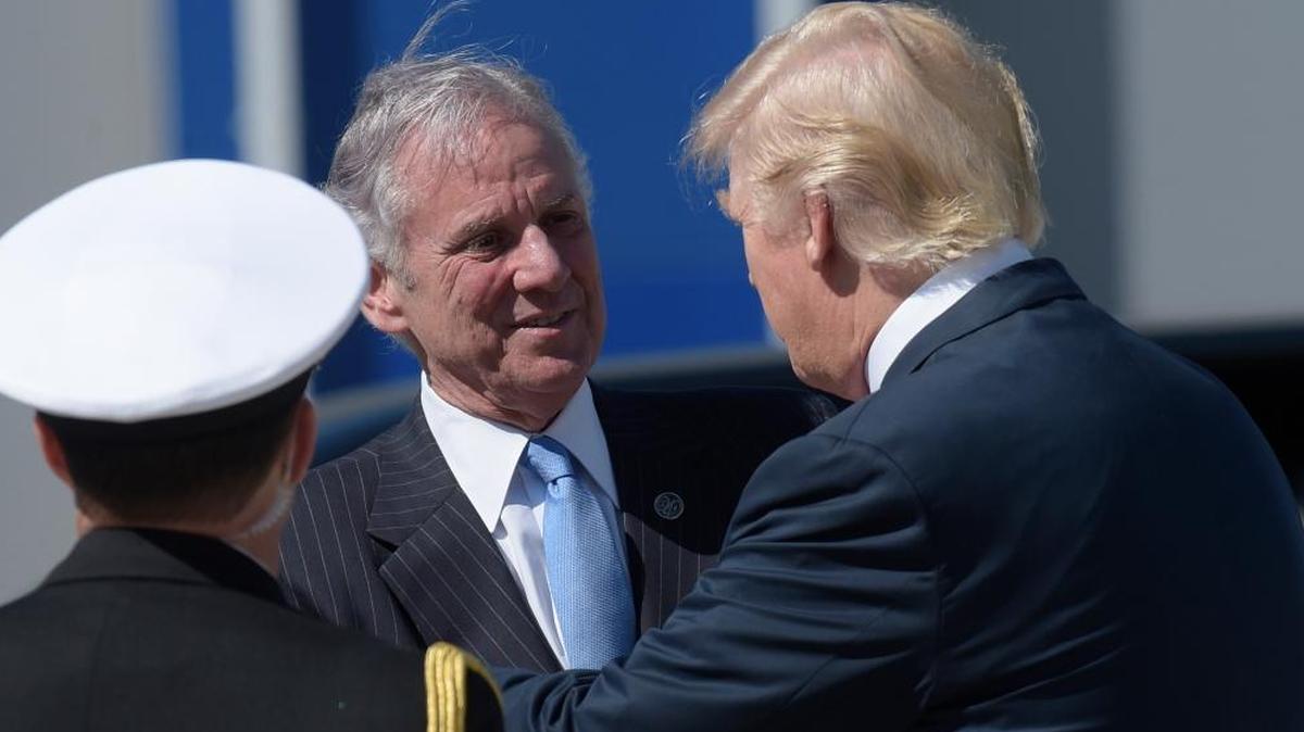 President Donald Trump shakes hands with South Carolina Gov. Henry McMaster after arriving on Air Force One at Charleston International Airport in North Charleston, S.C.