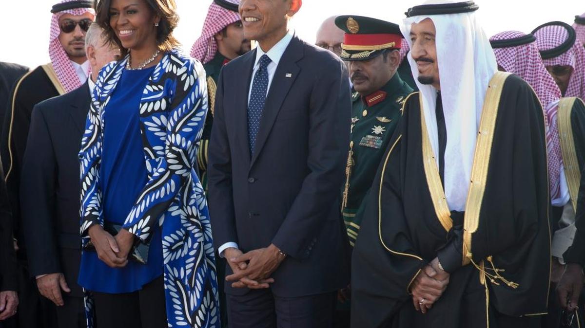 President Barack Obama and first lady Michelle Obama stand with new Saudi King Salman bin Abdul Aziz in January 2015 at King Khalid International Airport in Riyadh. Donald Trump criticized Michelle Obama for not covering her head. But Melania Trump also didn’t cover her head Saturday.