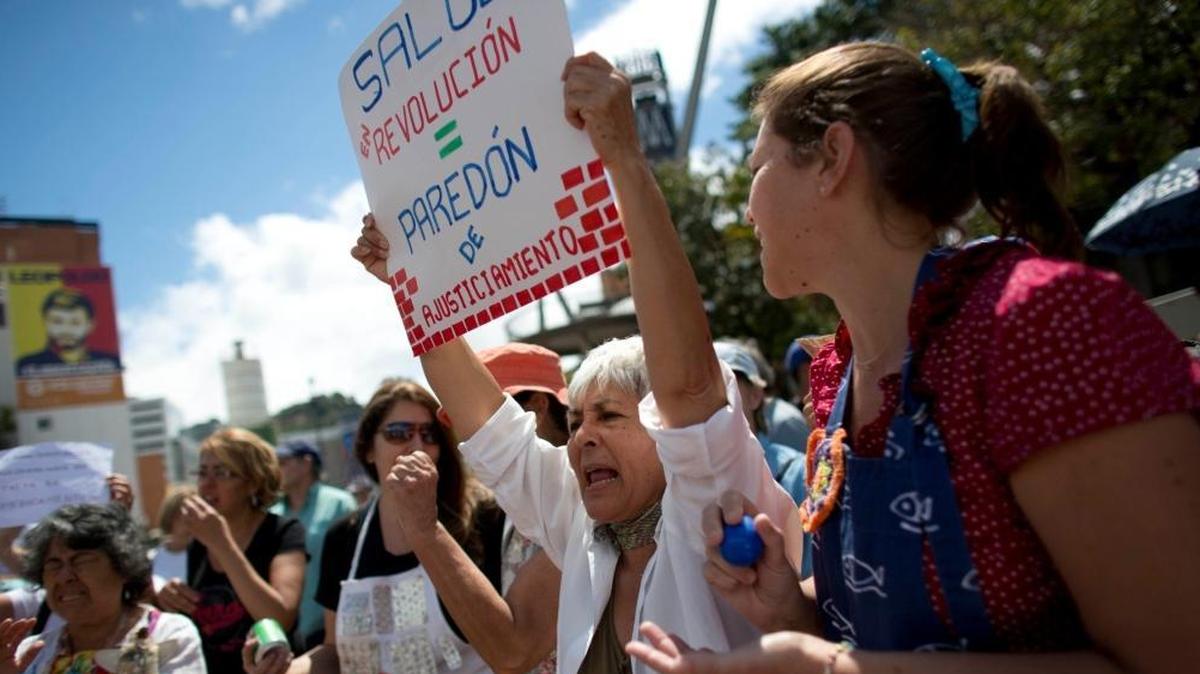 People take part in a protest demanding the government attend to the country's health crisis, in Caracas, Venezuela, Thursday, Feb. 8, 2018. Shortages of medicine, medical supplies and services are causing avoidable deaths in the South American country.