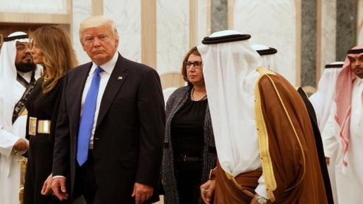 President Donald Trump and first lady Melania Trump walk with Saudi King Salman to a coffee ceremony and presentation ceremony of The Collar of Abdulaziz Al Saud Medal at the Royal Court Palace Saturday.