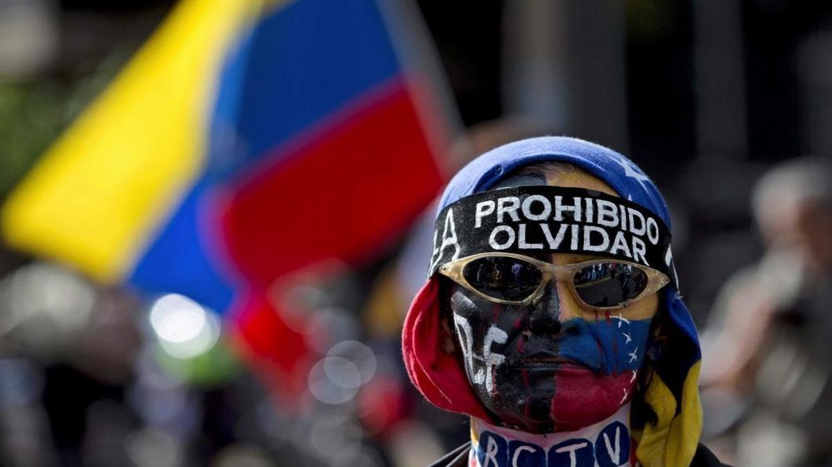 A demonstrator wore a banner that reads in Spanish: “Prohibited to forget” during a protest in Caracas, Venezuela, on Sunday.