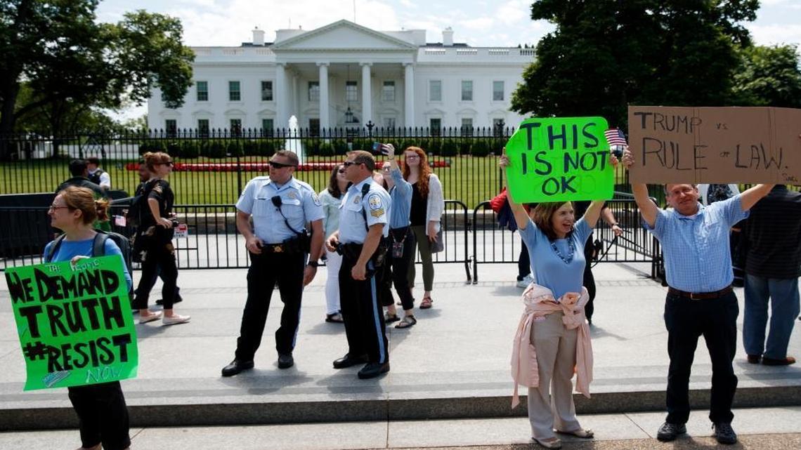 Demonstrators gather outside the White House a day after President Donald Trump fired FBI Director James Comey, Wednesday, May 10, 2017, in Washington.