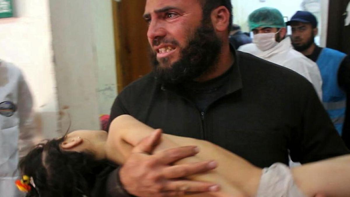 A photo by the anti-government activist group Edlib Media Center is said to show a man carrying a child after a suspected chemical attack in the town of Khan Sheikhoun in Syria.