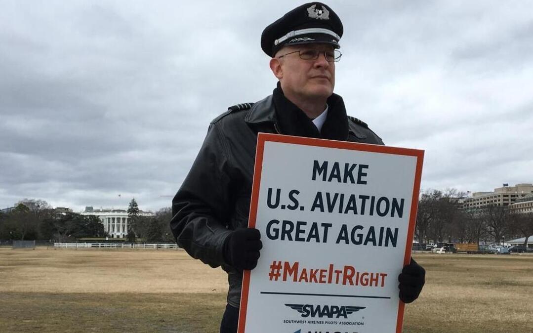 Southwest Airlines pilot Mike Panebianco rallies outside the White House on Tuesday, Jan. 24, 2017, to urge President Donald Trump to overturn an agreement that gives Norwegian Air additional U.S. routes. Airline unions say the Norwegian deal will lead to fewer American jobs.