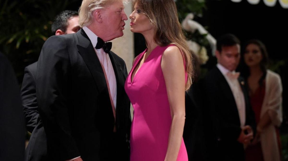 President Donald Trump talks with first lady Melania Trump as they arrive for the 60th annual Red Cross Gala at Trump's Mar-a-Lago resort in Palm Beach, Fla., Saturday, Feb. 4, 2017.